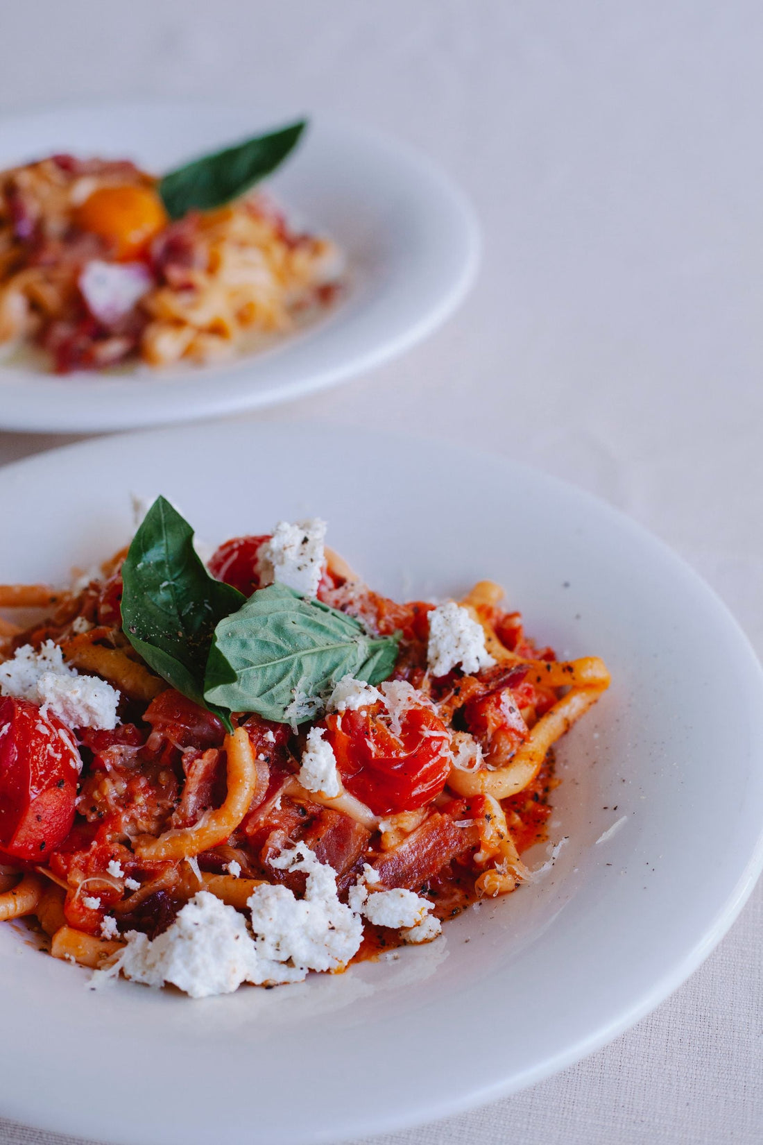 Pasta with tomato, basil and cheese – photo by Antonius Ferret, Pexels