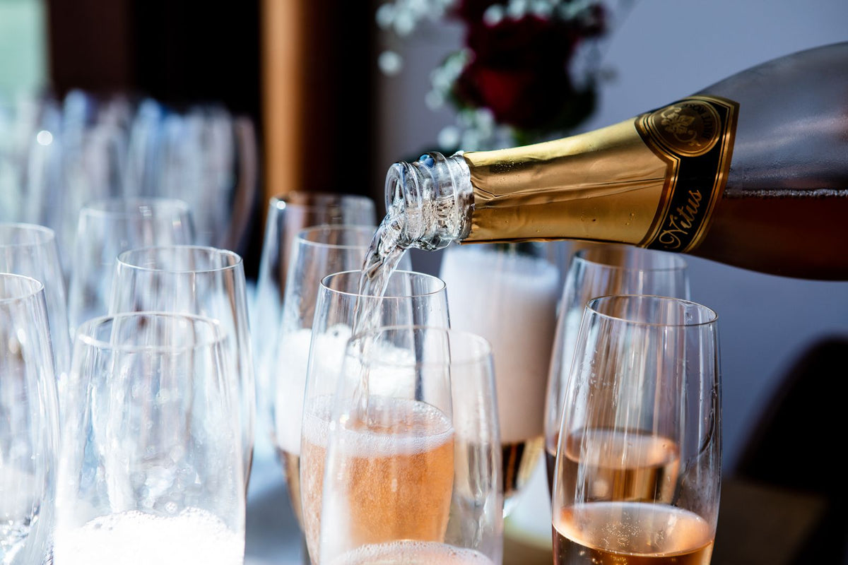 Sparkling wine poured into flutes – photo by Rene Terp, Pexels